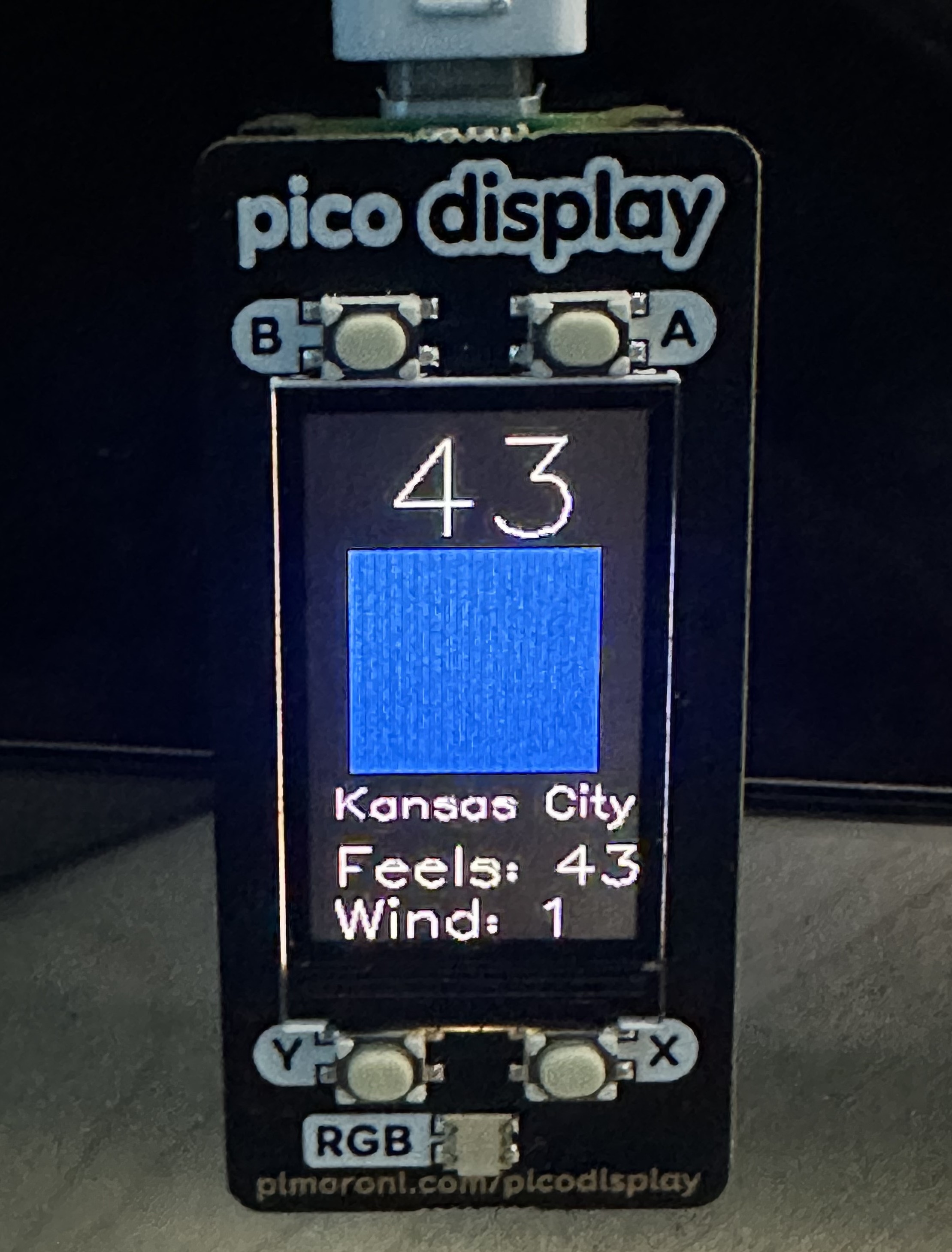 A photo the Pico W with the current weather screen displayed